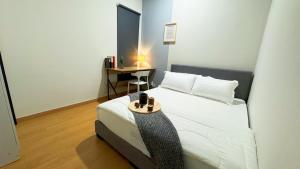 a bedroom with a bed and a table with a lamp at Bandar Gamuda Cove Splash Mania Fully Air Con Suite, 42700 Banting in Banting