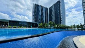 a large swimming pool in front of a building at Bandar Gamuda Cove Splash Mania Fully Air Con Suite, 42700 Banting in Banting