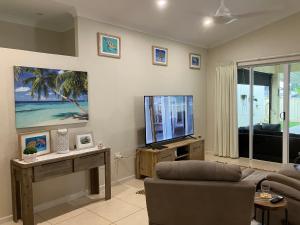 a living room with a tv and a couch at Sunriser in Kurrimine Beach