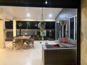 a living room with a couch and a table at Sunriser in Kurrimine Beach