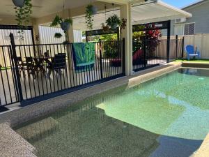 a swimming pool in front of a house at Sunriser in Kurrimine Beach