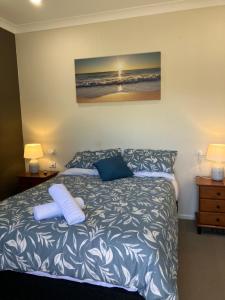 a bedroom with a bed with two pillows on it at Sunriser in Kurrimine Beach +15 photos