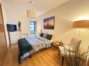 a bedroom with a bed and a couch and a tv at Lisbon Room S Joao Talha in São João da Talha