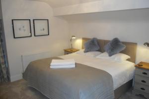 a bedroom with a bed with two pillows on it at The Hive at 52 in Northwich