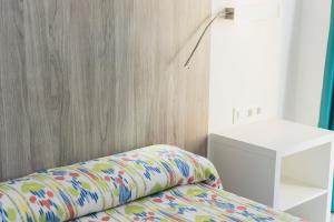 A bed or beds in a room at Hotel Amic Can Pastilla