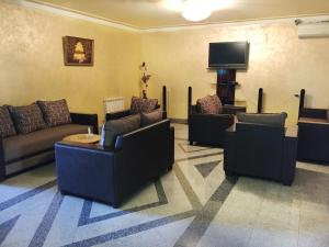 a living room with couches and a flat screen tv at Primer Hotel in Yerevan
