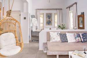 a living room with a couch and a swing at Althea Boutique Hotel - Adults Only in Amoopi