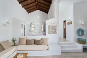 a living room with a couch and a bathroom at Althea Boutique Hotel - Adults Only in Amoopi
