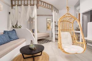 a living room with a white couch and a swing at Althea Boutique Hotel - Adults Only in Amoopi