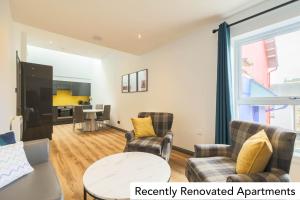 a living room with two chairs and a table at Holyrood Aparthotel in Edinburgh