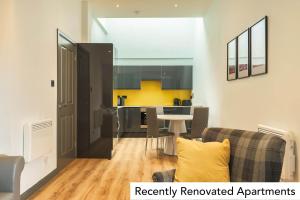 a living room with a couch and a table at Holyrood Aparthotel in Edinburgh