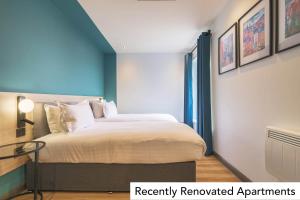 a bedroom with a bed and a glass table at Holyrood Aparthotel in Edinburgh