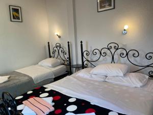 a bedroom with two beds and a rug at Skadar Lake Family Resort in Rijeka Crnojevića