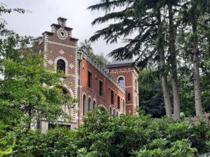 a brick building with a clock tower on it at Gerard Bronnen in Geraardsbergen