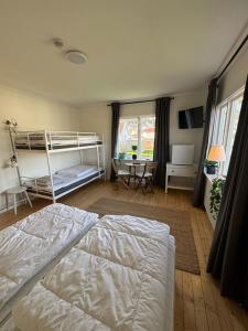 Lagunen Cottages and Hostel في سترومستاد: غرفة نوم مع سريرين بطابقين ومكتب