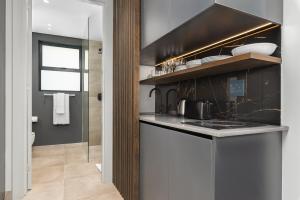 a kitchen with a sink and a stove top oven at One Calais Luxury Apartments in Cape Town