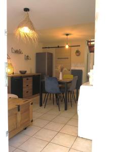 a kitchen and dining room with a table and chairs at Maison de village à 35 m du bord de mer in Marseille