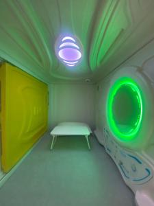 a room with a bench and a green light at Mermaid Space Capsule Hostel Palermo in Palermo