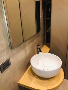 a bathroom with a white sink and a mirror at Residenza Avogadro in Turin