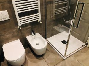 a bathroom with a toilet and a sink at Residenza Avogadro in Turin +34 photos
