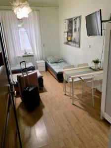 a living room with a bed and a table at Noclegi AVATAR Radom in Radom