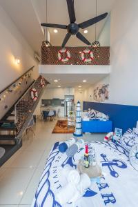 a bedroom with a bed with a blue and white bedspread at Ekocheras Cozy Loft in Kuala Lumpur +70 photos