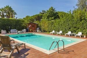 a large swimming pool with chairs and a house at Villa Romano in Nicolosi