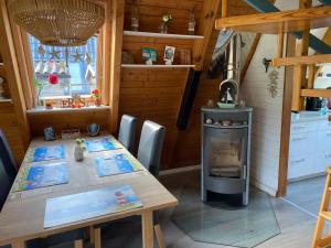 a dining room with a table and a stove at Ostseepirat in Damp