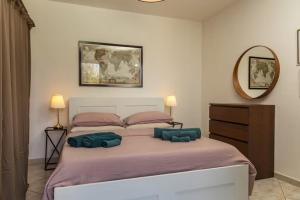 a bedroom with a bed with two blue pillows on it at Casa Vacanza Villa Romano in Nicolosi