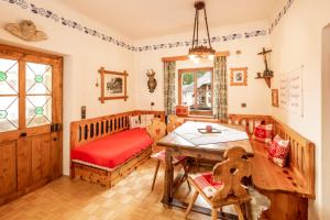 a room with a crib and a table and chairs at Schlossmeierhaus - Kristall Lungau in Mauterndorf