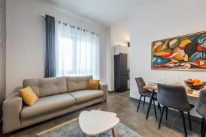 Royal Hill Apartments by PS في دوريس: غرفة معيشة بها أريكة وطاولة