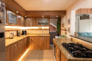 a kitchen with wooden cabinets and a stove top oven at Vista Verde in Cuba