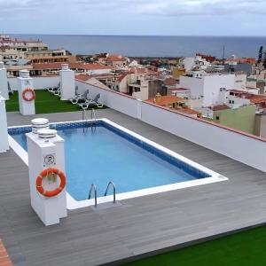 a swimming pool on the roof of a building at Puerto Cruz Relaxing Shared Pool in Puerto de la Cruz