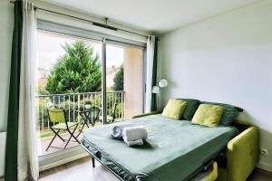 a bedroom with a bed and a large window at Villeurbanne La Doua / Insa in Villeurbanne