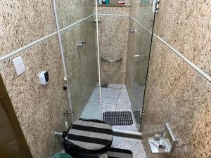 a bathroom with a glass shower with a toilet at Aconchego do peró in Cabo Frio +27 photos