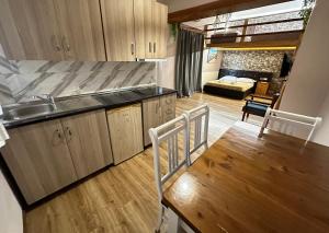 a kitchen with a sink and a table and a couch at Anel Suites in Vlorë