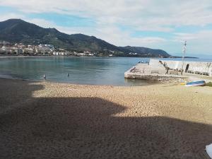 a view of a beach with people in the water at Casa Roberto in Cefalù