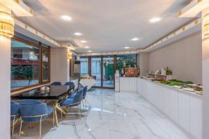 a dining room with a table and chairs at Safari Otel in Antalya