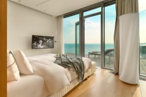 a bedroom with a bed with a view of the ocean at Radisson Blu Resort & Spa in Split