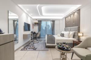 a hotel room with a bed and a living room at Mastiff Select Mandavya Dharamkot, McLeodganj in Dharamshala