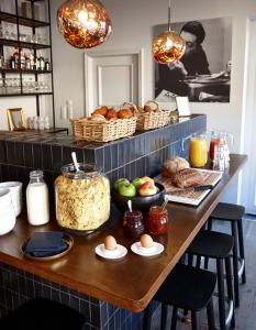 a table with eggs and bread and baskets of food at Hotel Monsieur Ernest in Bruges