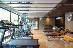 a gym with a bunch of exercise bikes in it at brown condo Phahon67 in Ban Chuat Plai Mai