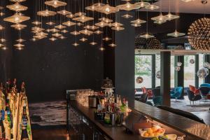 a bar in a restaurant with a bunch of lights at Motel One Berlin-Tiergarten in Berlin