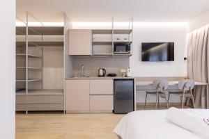 a bedroom with a kitchen and a dining room at ENeR Studios in Tirana