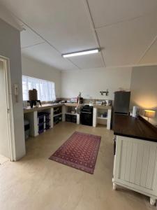 an empty room with a kitchen with a rug on the floor at Valley View Cottage Unit 8 Hilltop Farm in Rosetta