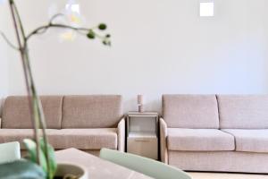 a living room with two couches and a table at Colombo - Boutique Home in Florence in Florence