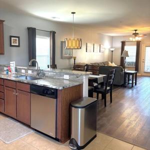 a kitchen and living room with a sink and a counter at Barefoot Bungalow in North Myrtle Beach