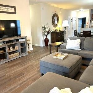 a living room with two couches and a flat screen tv at Barefoot Bungalow in North Myrtle Beach +57 photos
