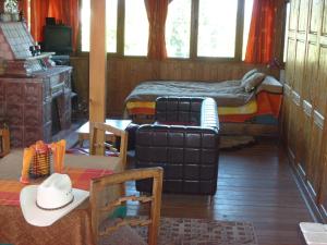 a room with a bed and a couch and a table at Transylvania Cowboy Cottage in Cluj-Napoca +30 photos