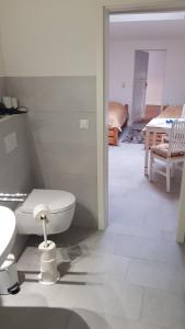 ein weißes Badezimmer mit Toilette und Waschbecken in der Unterkunft Altstadtloft Lüneburg in Lüneburg + 29 Fotos